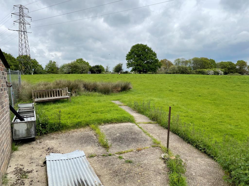 Lot: 35 - FREEHOLD SMALLHOLDING PLUS NINE ACRES OF LAND WITH POTENTIAL - View of land and pylon from rear of building